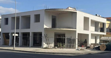 For sale: A fully renovated building on a prime commercial Avenue offering shops on the ground level and apartments on the upper level