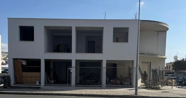 For sale: A fully renovated building on a prime commercial Avenue offering shops on the ground level and apartments on the upper level